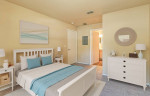 Cozy bedroom in a spacious apartment at Enclave at Pine Oaks, featuring a queen bed and modern decor.