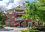 Exterior view of Rose Heights Apartments in Raleigh, featuring lush landscaping and modern architecture.