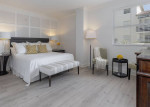 Luxurious bedroom in a pet-friendly apartment with modern décor and natural light in Coral Gables, FL.