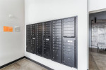 Mailboxes in the modern lobby of Woolen Mills Lofts, Appleton, WI, featuring urban design and spacious amenities.
