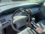 Interior view of a 2004 Toyota Avalon XLS with gray leather seats and dashboard features.