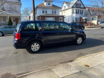 2012 Dodge Grand Caravan parked on the street, featuring Stow and Go seats and low mileage of 97k.