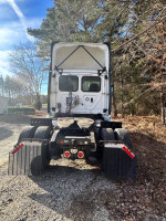 Rear view of a 2018 Freightliner 113 Day Cab, featuring clean exterior and well-maintained tires and chassis.