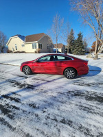 2018 Chevrolet Malibu LT in pristine condition parked on snow-covered street, showcasing its sleek design.