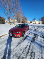 2018 Chevrolet Malibu LT in pristine condition parked on snowy driveway, showcasing its sleek design.