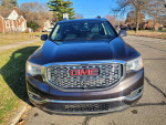 Front view of a 2017 GMC Acadia Denali FWD showcasing its sleek design and distinctive grille.