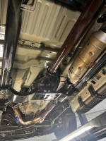 Undercarriage view of a rust-free 2001 Ford Excursion with a rebuilt transmission and well-maintained components.