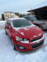 2015 Chevrolet Sonic LTZ Turbo parked in snow, showcasing its sleek design and winter readiness.