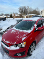 2015 Chevrolet Sonic LTZ with snow on it, showcasing exterior and condition in a winter setting.