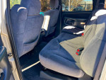 Interior view of a 2001 GMC Sierra 2500HD showing spacious back seats in clean condition.
