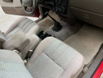 Interior view of a well-maintained 1995 Toyota Tacoma with comfortable seating and gear shift