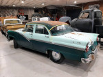 Antique Ford car with vintage design in a garage, showcasing classic automotive history.