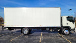 2021 Isuzu FTR box truck in a parking lot, showcasing a white exterior and liftgate features.