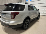 2013 Ford Explorer Sport AWD in silver, showcasing rear view and details like alloy wheels and panoramic roof.