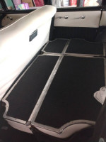 Interior shot of a classic 1956 Chevrolet Belair 9 passenger wagon showcasing the seating area.