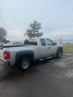 2012 Chevrolet Silverado 1500 4x4 pickup truck parked near a beach with 105k miles, strong engine and good condition.
