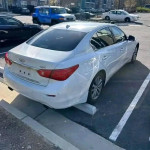 White INFINITI Q50 parked, featuring a sleek design and clean title, ideal for financing options.