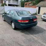 Rear view of a green Honda Accord parked with tinted windows and clean title, ideal for financing.