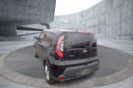 2015 Kia Soul wagon in shadow black, showcasing rear view with modern architecture background.