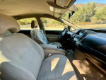 Interior view of a 2005 Toyota Prius, featuring beige upholstery and modern dashboard design.