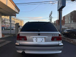 Rear view of a 2002 BMW 5 Series 525i Wagon in silver, showcasing its sleek design and alloy wheels.