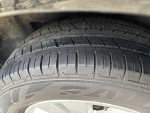 Close-up of a well-treaded tire on a 2017 Subaru Outback, showcasing its quality for all-terrain driving.