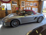2008 Porsche Boxster RS 60 Spyder in silver with red leather interior parked in a garage