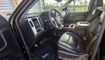 Interior view of a 2018 GMC Sierra 1500 SLT showing leather seats, dashboard, and modern features.