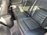 Interior view of a 1994 Ford Mustang GT showing black leather seating and clean condition.