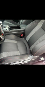 Interior view of 2017 Honda Civic EX showing front seats and center console, featuring clean design and sporty details.