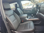 Interior of 2023 GMC Sierra 1500 showing black leather seats and modern dashboard features.