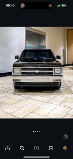 Front view of a 1992 Chevrolet S-10 Tahoe truck, showcasing its shiny chrome grille and well-maintained exterior.