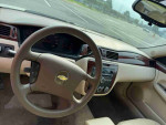 Interior view of a 2012 Chevrolet Impala LS showcasing the dashboard and steering wheel.