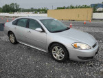 2011 Chevrolet Impala LS sedan with 201,700 miles, reliable and budget-friendly, parked on gravel.