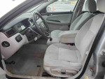 Interior view of a 2011 Chevrolet Impala LS with cloth seats and dashboard features.
