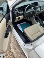 Interior view of a 2015 Honda Accord EX with beige leather seats and modern dashboard features.