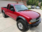 2003 Chevrolet S-10 LS ZR2 extended cab truck in red, low mileage, clean interior and exterior, available for $2,500.