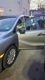 2018 Honda Odyssey LX with open door, showcasing interior space and clean condition.
