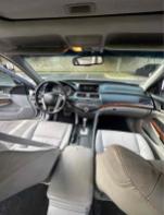 Interior view of a 2012 Honda Accord EX-L V-6 showing leather seats and dashboard features.