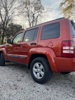 2009 Jeep Liberty in burnt orange, great condition with spacious dark gray interior and large trunk.