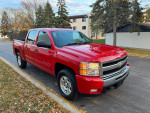 2011 Chevrolet Silverado 1500 LT 4WD red pickup truck parked on the street with clean exterior