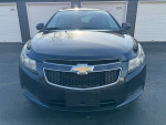 Front view of a 2014 Chevrolet Cruze 1LT sedan in excellent condition, showcasing its clean body and durable performance.