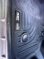 Close-up of a Husky Liners floor mat in a 2015 Ford F350, highlighting its durable design and guaranteed for life label.