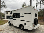 2012 Thor Motor Coach Majestic 19G motorhome parked in a driveway surrounded by trees