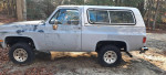 Side view of a 1990 Chevrolet Blazer parked outdoors, featuring a rebuilt 350 engine and new parts.