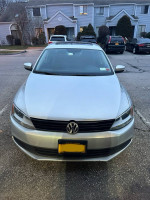 Front view of a silver 2011 Volkswagen Jetta for sale, featuring clean lines and well-maintained condition.