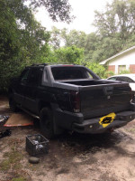 2013 Chevy Avalanche 1500 Z71 in the yard with mechanic tools and nature surroundings.