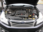 Engine compartment of a 2012 Subaru Outback 2.5i AWD, showcasing maintained features and parts.