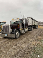 1996 Peterbilt 379 extended hood truck with a trailer, showcasing new engine and driveline components.