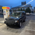 2004 Land Rover Discovery parked at a gas station, ready for sale or trade, with minor overheating issues.